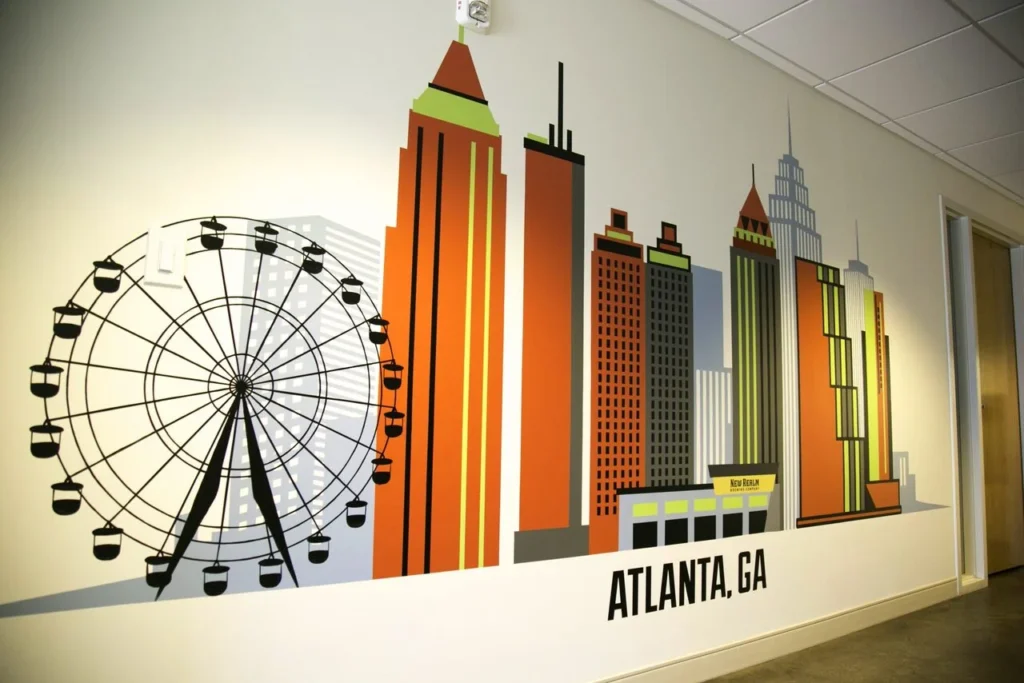 Hand-painted mural in Atlanta, GA. Cityscape with sharp geometric forms.