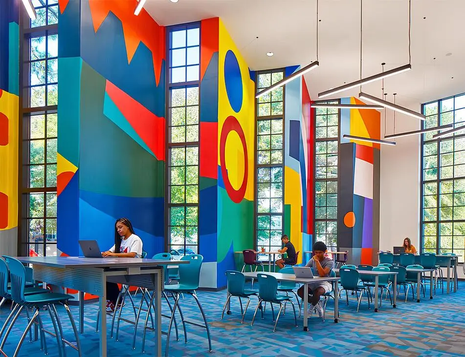 Colorful abstract mural in a modern library or study space.